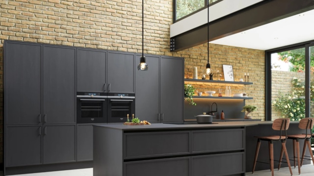 The Aylesford kitchen in graphite with dark oak barstools.