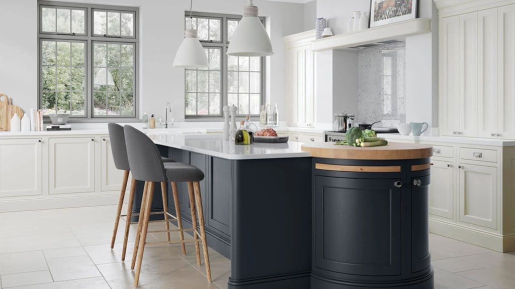 The Belgravia kitchen in slate blue with white marble worktops and an oak accent worktop.