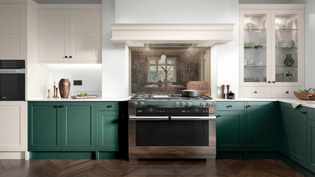 The Clifden kitchen in dark green featuring dark green cupboards surrounding the oven.
