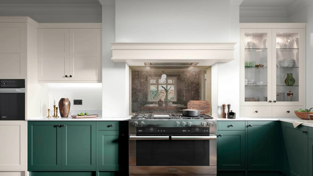 The Clifden kitchen range in heritage green with white marble worktops.