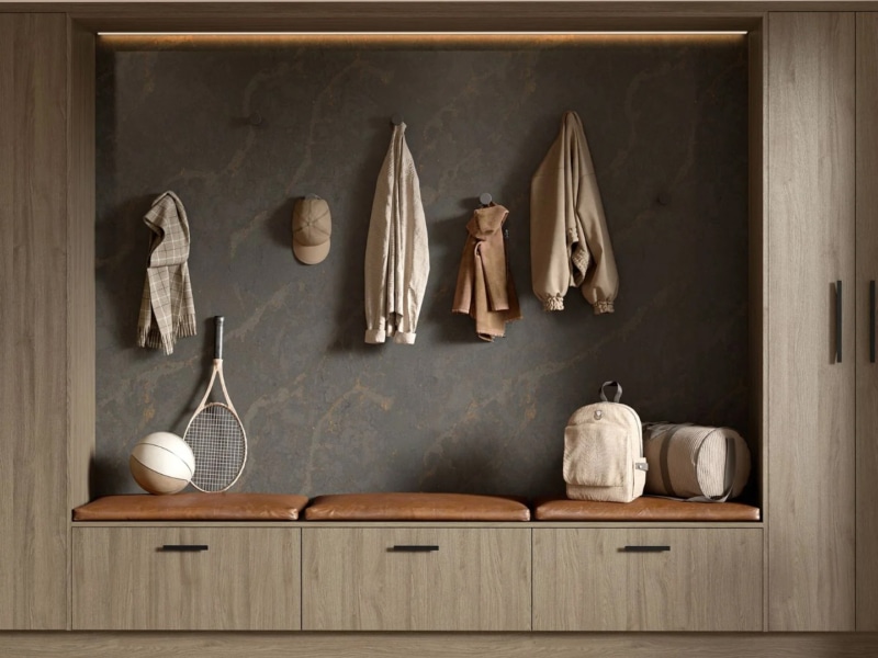 A stori with a wooden finish in a utility room with light brown leather cushions on it.